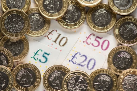 UK five pound, ten pound, twenty pound and fifty pound notes with one pound coins.