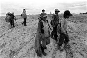 In Cambodia, children trudge through mountains of rubbish looking for food and scraps to sell