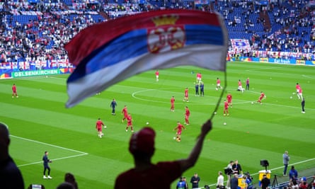 A Serbia supporter waves a flag before the game against England.