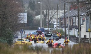Rescue operations continue as emergency services take residents of Oxford Street, Nantgarw to safety on inflatable rafts.