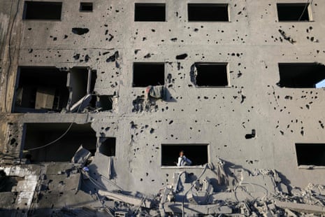 A Palestinian youth walks inside a shrapnel-riddled building damaged in Khan Younis.