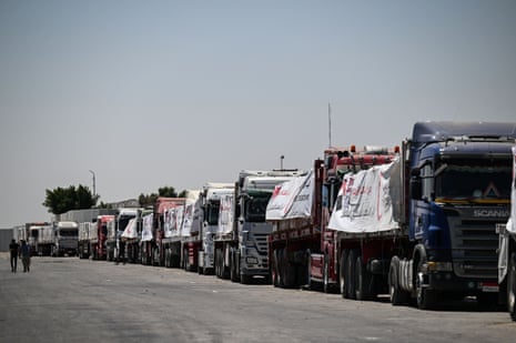 Trucks loaded with humanitarian aid bound for the Gaza Strip wait at the Rafah border gate, between Egypt and the Gaza Strip.