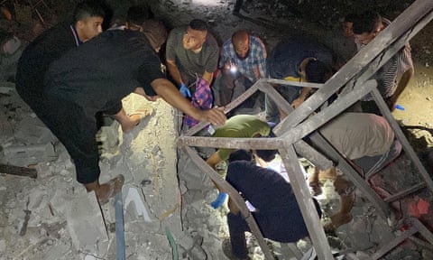 People on rubble of destroyed home.