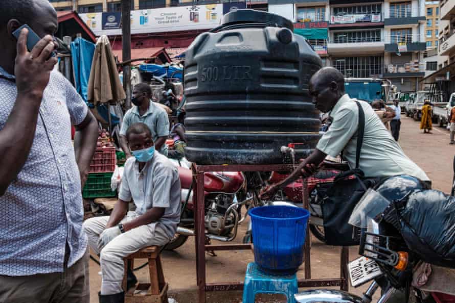 Sumaya Sadurni: photojournalist and ‘rock’n’roll Mother Teresa’ dies at 32 | Uganda 4 People wash their hands before entering Nakasero market in Kampala
