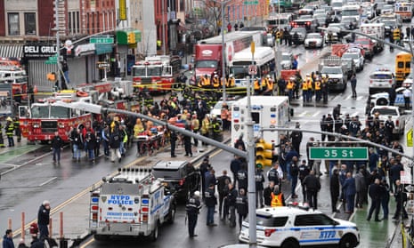 Members of the New York police department and emergency vehicles crowd the streets in Sunset Park following the shooting.