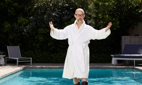 Moby in a white dressing gown and black boots by Los Angeles swimming pool