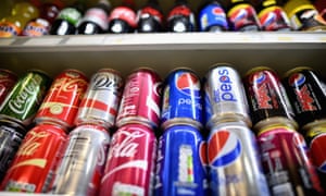 Cans of soft drinks on a shelf