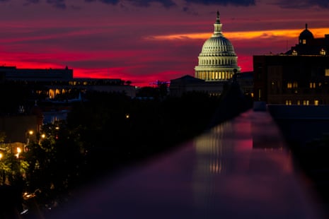 the sun sets behind the capitol dome