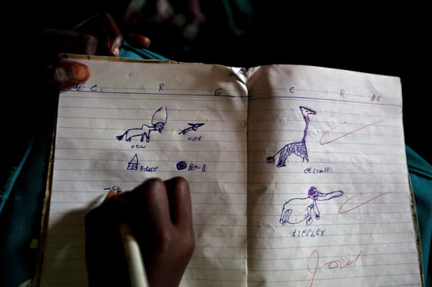 A girl draws animals in her schoolbook at Pibor primary school, South Sudan.