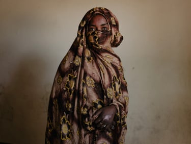 A woman in a robe that covers all but her eyes and hands