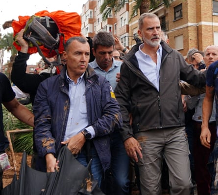 Carlos Mazón, centre, and King Felipe VI, right, are heckled in Paiporta