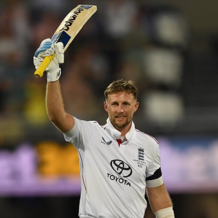 Joe Root holds his bat aloft to acknowledge the applause of fans