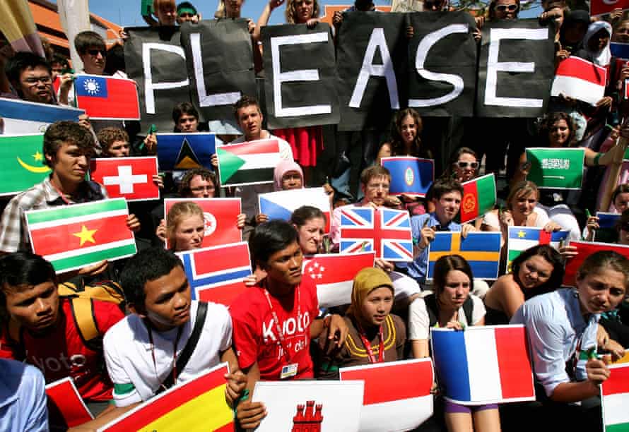 Protesters with national flags and a sign saying 'Please'