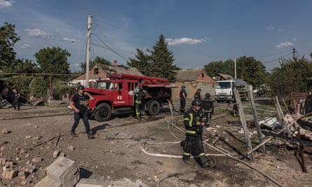 Red truck and emergency services personnel at the scene of bomb strike