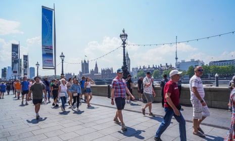 People walking on the South Bank on a sweltering day in London in early June.
