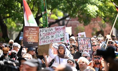 A dense crowd of protesters holding placards in Melbourne