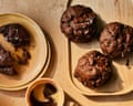 Edd Kimber's double chocolate olive oil cookies on plates, beside cups of coffee
