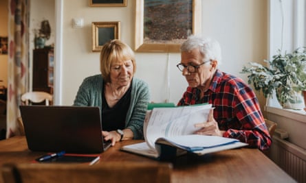 Senior couple using laptop at home