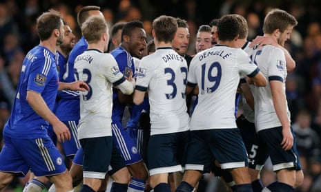 The Chelsea and Tottenham players surround Mark Clattenberg during one of many flashpoints in a bad-tempered game which ended with Spurs surrendering the title.