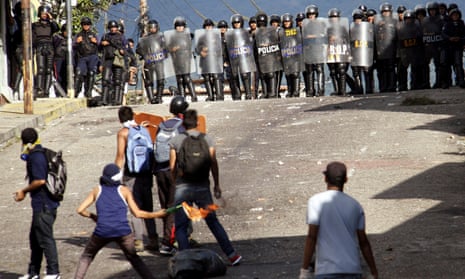 Demonstrators clash with riot police during a rally to demand a referendum to remove Nicolas Maduro in San Cristobal, Venezuela on 24 October 2016.