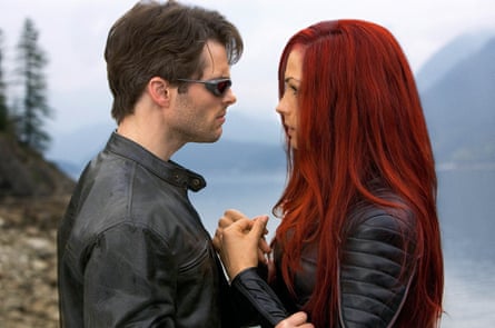 Janssen and Marsden clasp hands on a mountainside