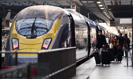 Passengers board a EuroStar train at St Pancras International train station in London.