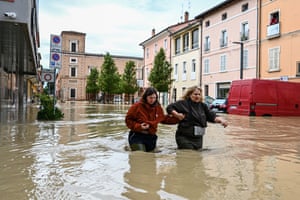 People wade through flood water in Castel Bolognese near Imola