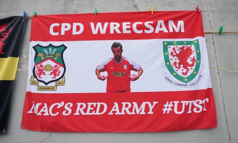 A sign depicting Rob McElhenney outside the Racecourse Ground.