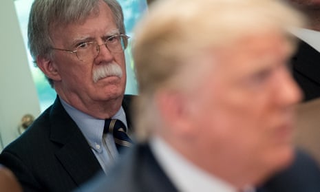 John Bolton listens as Donald Trump speaks during a cabinet meeting in 2018. 