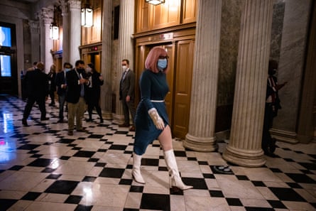 Kyrsten Sinema heads to the Senate floor on 20 December 2020 wearing a bright purple wig, a green dress and white knee-high boots.