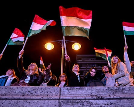 People waving Hungarian flags