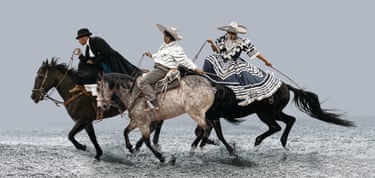 Three women riding horses against a pale, misty background.