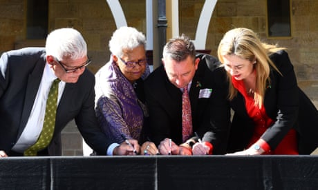Mick Goodna, Dr Jackie Huggins, Craig Crawford MP, and Queensland Premier Annastacia Palaszczuk, sign path to treaty documents during the signing of an Indigenous Treaty commitment statement at Parliament House in Brisbane, Tuesday, August 16, 2022. (AAP Image/Jono Searle) NO ARCHIVING
