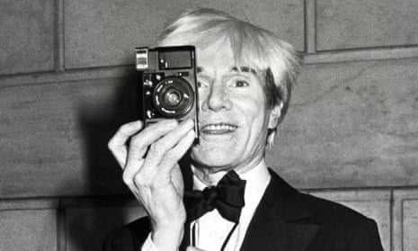 Andy Warhol holding up camera