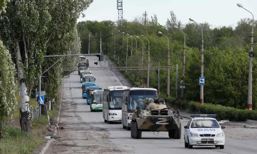 Buses carrying service members of Ukrainian forces at Azovstal steel works drive away under escort of the pro-Russian military.