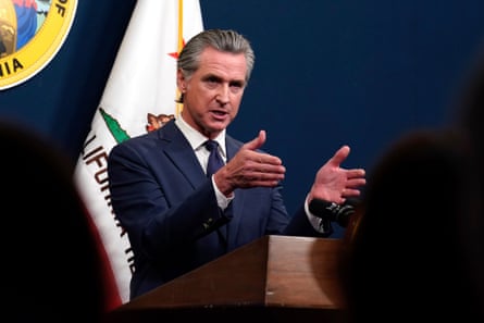 a man in a suit speaks into a microphone