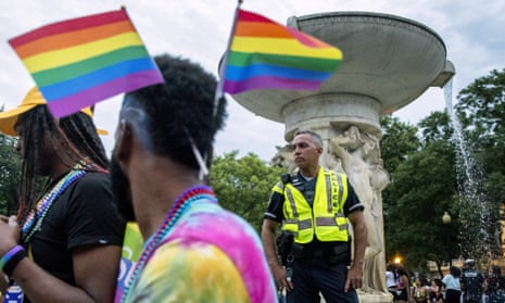 A police officer watches the crowd at the conclusion of the Capitol Pride Parade at Dupont Circle in Washington, 8 June 2019. 