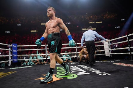 Canelo Álvarez knocks down Jaime Munguía during the fourth round of Saturday’s fight.