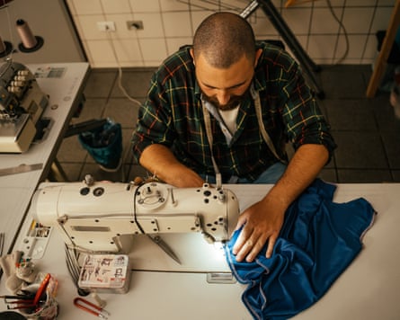Tailor working with a sewing machine.