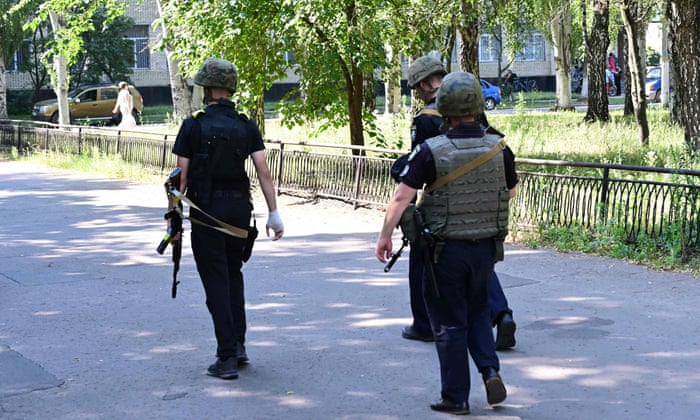 Ukrainian police officers patrol the city of Sloviansk, on July 6, 2022, amid the Russian invasion of Ukraine.