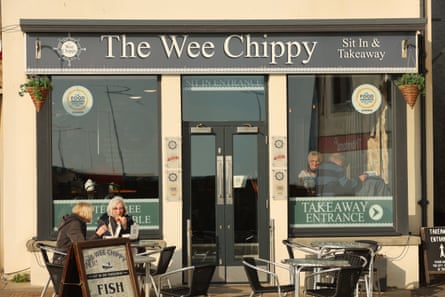 People eat inside and outside the Wee Chippy fish and chip shop