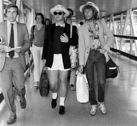 Happy landings: Elton John arrives home from his holidays in 1981.