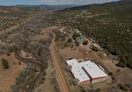 areal view of buildings amid wide landscape of trees and barren land