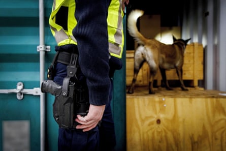 A customs officer with a sniffer dog at the Port of Rotterdam.