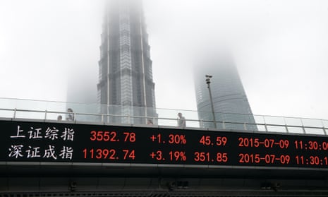 In this July 9, 2015 photo, people walk on a footbridge with an electronic stock ticker showing real time stock market indices at Lujiazhui Financial and Trade Zone in Shanghai.