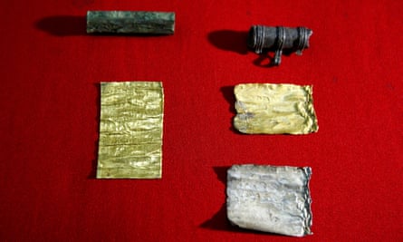 Two amulets have been discovered, containing rolls of silver and gold