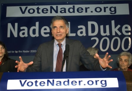 a man in a suit speaks into a microphone