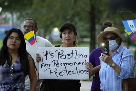 Protester holds sign saying ‘it’s post time for permanent protection’