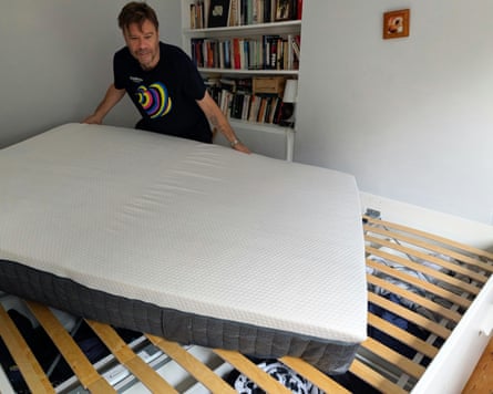 The Emma Hybrid Premium Mattress being placed on an Ikea slatted bed base.