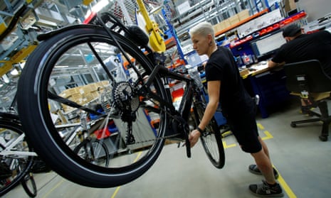 An employee works on an electric bicycle at a factory in Germany